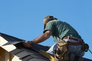 worker on roof putting shingles down, Dowell Roofing, Murfreesboro Roofers